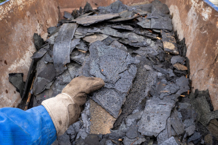 Throw Old Removed Roofing Felt Into A Waste Container